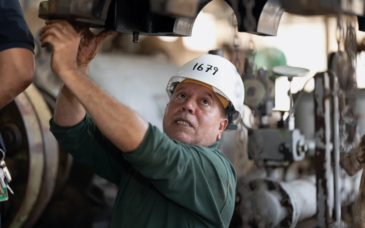 Engineer inspecting and documenting industrial machinery on site