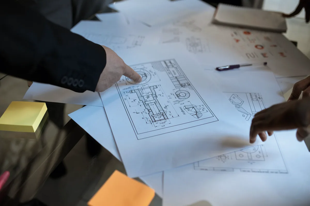 Team using project drawings to clarify workflow and enterprise context